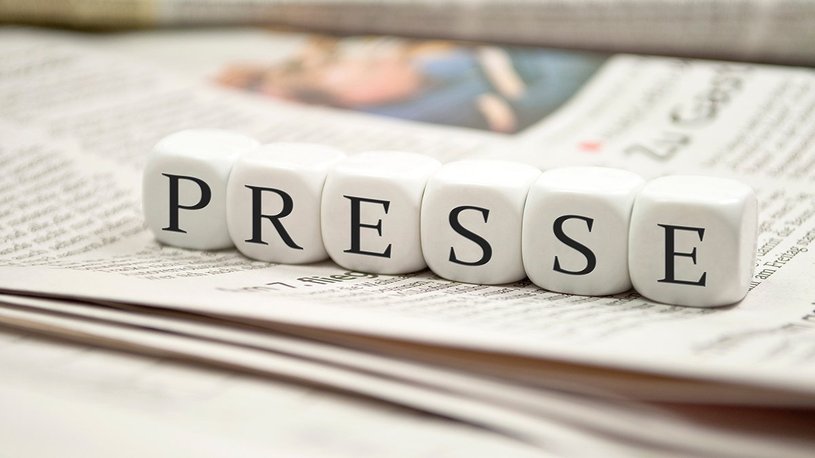 Kleine Würfel, auf denen das Wort Presse steht, liegen auf einer Zeitung Kleine Würfel, auf denen das Wort Presse steht, liegen auf einer Zeitung
